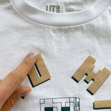 Load image into Gallery viewer, Uniqlo Minecraft T-Shirt White/Gold Letters (4y)
